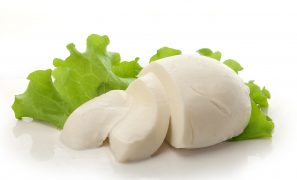 94717920 - sliced ball of mozzarella with fresh green lettuce